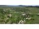 Rolling hills and green landscape dotted with rock outcrops, offering scenic views and natural beauty at 8821 S Perry Park Rd, Larkspur, CO 80118