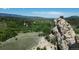 Scenic view featuring a rugged rock formation amidst a lush green landscape, capturing the essence of nature at 8821 S Perry Park Rd, Larkspur, CO 80118