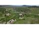 Scenic landscape featuring rocky outcrops and distant mountains, offering a peaceful and picturesque setting at 8821 S Perry Park Rd, Larkspur, CO 80118