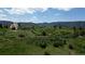 Scenic landscape featuring lush greenery, scattered trees, and rock formations, creating a serene and natural environment at 8821 S Perry Park Rd, Larkspur, CO 80118