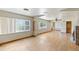 Open living room featuring hardwood floors, multiple windows, and a ceiling fan at 8821 S Perry Park Rd, Larkspur, CO 80118