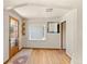 Inviting living room with a windowed door and light wood floors at 8821 S Perry Park Rd, Larkspur, CO 80118