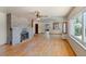 Spacious living room featuring hardwood floors, natural light, and a classic fireplace at 8821 S Perry Park Rd, Larkspur, CO 80118
