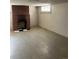 Spacious basement featuring a brick fireplace and tile flooring at 2134 S Corona St, Denver, CO 80210