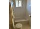 Clean bathroom featuring white tile walls, a tub, and a toilet at 2134 S Corona St, Denver, CO 80210