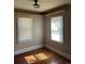 Cozy bedroom featuring hardwood floors, two windows with blinds, and a built-in shelf at 2134 S Corona St, Denver, CO 80210