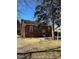 Exterior view of the charming brick home with a well-maintained backyard and a red door at 2134 S Corona St, Denver, CO 80210