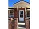 Charming brick home featuring a white front door and covered porch at 2134 S Corona St, Denver, CO 80210