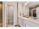 Elegant bathroom featuring double sinks and a spacious walk-in closet at 12749 Horton Ct, Parker, CO 80134
