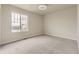 Bright bedroom features a large window with neighborhood views and neutral carpeting at 12749 Horton Ct, Parker, CO 80134