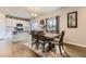 Dining area with wood table and chairs plus an adjacent kitchen with white cabinets at 12749 Horton Ct, Parker, CO 80134