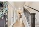 Inviting entryway featuring wood floors, staircase, and decorative glass doors at 12749 Horton Ct, Parker, CO 80134