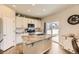 Bright kitchen with white cabinets, granite countertops, and a stainless steel microwave at 12749 Horton Ct, Parker, CO 80134