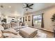 Spacious living room with an overhead fan and a window viewing the backyard gazebo at 12749 Horton Ct, Parker, CO 80134