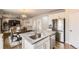 Open concept living space with an island, dining room, stainless steel appliances, and seating at 12749 Horton Ct, Parker, CO 80134