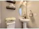 Charming powder room with pedestal sink, decorative mirror, and stylish accents at 12749 Horton Ct, Parker, CO 80134