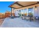 Relaxing covered patio featuring modern furniture and an outdoor dining area, perfect for entertaining guests at 6650 Zuni St, Denver, CO 80221