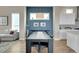 Stylish dining room with a dark wood table, a blue accent wall, and ample natural light at 6650 Zuni St, Denver, CO 80221