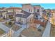 Aerial view of a modern two-story home with a gravel front yard and a patio with a grill at 6650 Zuni St, Denver, CO 80221