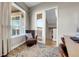 Cozy home office nook with a comfortable armchair, natural light, and an elegant rug on the hardwood floors at 6650 Zuni St, Denver, CO 80221