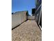 Gravel backyard with white fence, gate, and exterior view of the property at 5060 N Walden Way, Denver, CO 80249