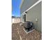 Backyard with gravel, patio slider, AC unit, and exterior view of the home at 5060 N Walden Way, Denver, CO 80249