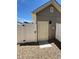 Backyard view of a door with a gravel ground and white fence at 5060 N Walden Way, Denver, CO 80249