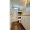 A clean and bright bathroom with a shower-tub combo, white fixtures, and wood-look flooring offers a refreshing space at 5060 N Walden Way, Denver, CO 80249