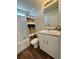 A clean bathroom features white fixtures, wood-look flooring, and a shower with a stylish curtain at 5060 N Walden Way, Denver, CO 80249