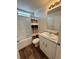 A bright bathroom features white fixtures, a shower-tub combination, and wood-look flooring, creating a clean aesthetic at 5060 N Walden Way, Denver, CO 80249