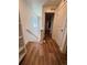 Bright hallway with wood-look floors and stairs, offering a view of the interior layout at 5060 N Walden Way, Denver, CO 80249