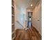 Bright hallway featuring wood-look floors, white walls, and a staircase leading to another level at 5060 N Walden Way, Denver, CO 80249