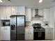 Modern kitchen featuring stainless steel appliances, white cabinets, and granite countertops at 5060 N Walden Way, Denver, CO 80249