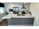 Modern kitchen with white cabinets, stainless steel appliances, and stylish kitchen island at 5060 N Walden Way, Denver, CO 80249