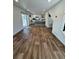 Spacious living room with sliding glass doors, hardwood floors, and an open view to the kitchen at 5060 N Walden Way, Denver, CO 80249