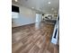 Bright living room with hardwood floors and open layout to kitchen and sliding doors at 5060 N Walden Way, Denver, CO 80249