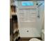 Clean shower with built-in shelves and a window, offering a minimalist design and bright space at 5060 N Walden Way, Denver, CO 80249