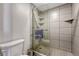 Modern bathroom featuring a walk-in shower with a glass door and tiled walls, plus gray towel at 1777 Larimer St # 2201, Denver, CO 80202