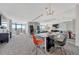 Open-concept living and dining area with contemporary furnishings and stunning city views at 1777 Larimer St # 2201, Denver, CO 80202