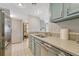 Bright kitchen featuring stainless appliances and lovely light blue cabinetry at 1777 Larimer St # 2201, Denver, CO 80202
