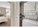 Convenient laundry area featuring stackable washer and dryer, adjacent to bedroom at 1777 Larimer St # 2201, Denver, CO 80202