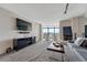 Living room with a fireplace, large TV and amazing city views at 1777 Larimer St # 2201, Denver, CO 80202