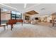 Expansive lounge area featuring ample seating, a baby grand piano, modern lighting, and large windows at 1777 Larimer St # 2201, Denver, CO 80202