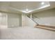 Spacious carpeted basement with staircase and recessed lighting, offering versatile living space at 2107 Ridge Plaza Dr, Castle Rock, CO 80108