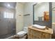 Charming bathroom with glass shower, tiled accents, vessel sink, and decorative vanity at 2107 Ridge Plaza Dr, Castle Rock, CO 80108