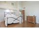 Bedroom with a high ceiling, clerestory windows, hardwood floors, and rustic wooden door at 2107 Ridge Plaza Dr, Castle Rock, CO 80108
