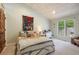 Cozy bedroom with sloped wood plank ceiling, patterned wall hanging, and exterior views from the window at 2107 Ridge Plaza Dr, Castle Rock, CO 80108