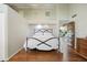 Neutral bedroom with a high ceiling, clerestory windows, hardwood floors, and wooden door at 2107 Ridge Plaza Dr, Castle Rock, CO 80108