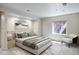 Bright bedroom features a plush bed, neutral decor, and a comfortable chair by the window at 2107 Ridge Plaza Dr, Castle Rock, CO 80108