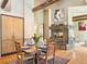 Dining room with hardwood floors, exposed beam, stone fireplace and custom built-in storage at 2107 Ridge Plaza Dr, Castle Rock, CO 80108